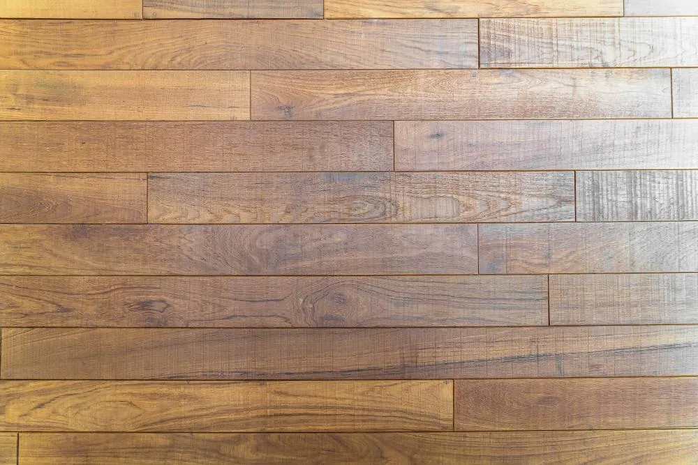 Detalle de la textura realista de un piso laminado que imita las vetas naturales de la madera.